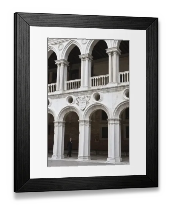 Framed Print : Italy, Venice. Man walks beneath the arches of the interior of Doges Palace Framed Print : Italy, Venice. Man walks beneath the arches of the interior of Doges Palace
