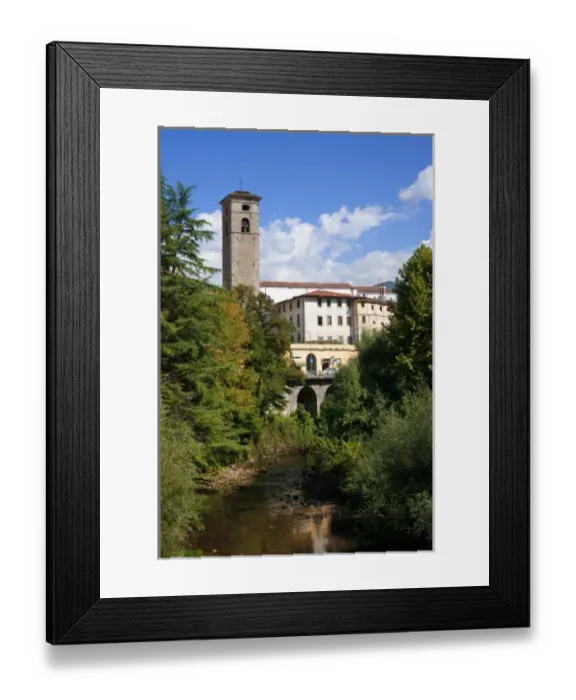 Framed Print : Castelnuovo di Garfagnana, Tuscany, Italy - Old world buildings as seen behind a small waterway
