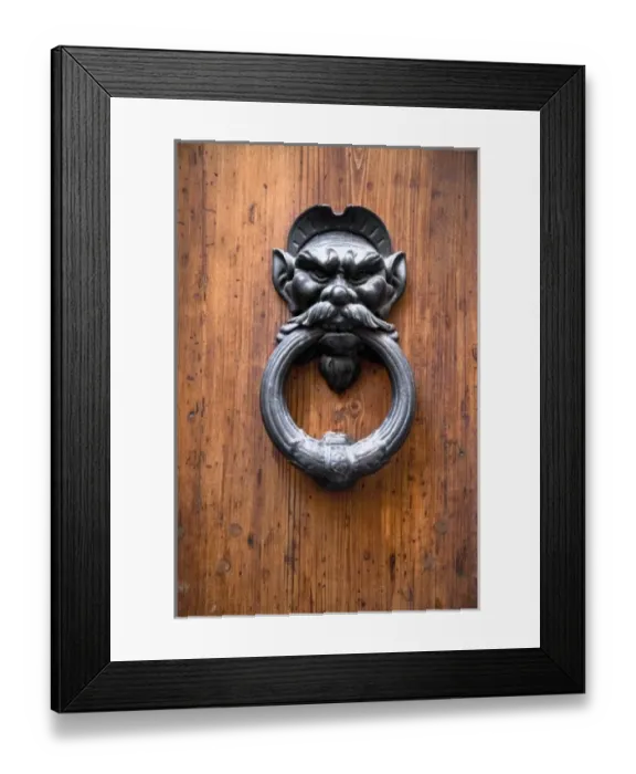 Framed Print : Sienna, Tuscany, Italy - Closeup of a metal door knocker in the shape of a mans face Framed Print : Sienna, Tuscany, Italy - Closeup of a metal door knocker in the shape of a mans face