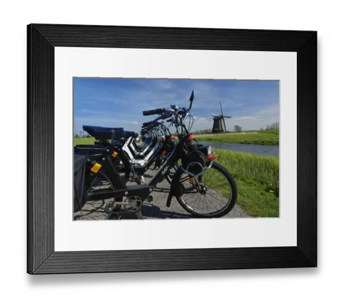 Framed Print : Row of bicycles along on dike along canal, and distant windmill, Holland, Netherlands Framed Print : Row of bicycles along on dike along canal, and distant windmill, Holland, Netherlands