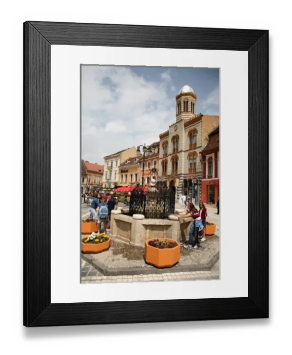 Framed Print : Europe, Romania, Brasov, Childern play with water of the fountain with Adormirea Framed Print : Europe, Romania, Brasov, Childern play with water of the fountain with Adormirea