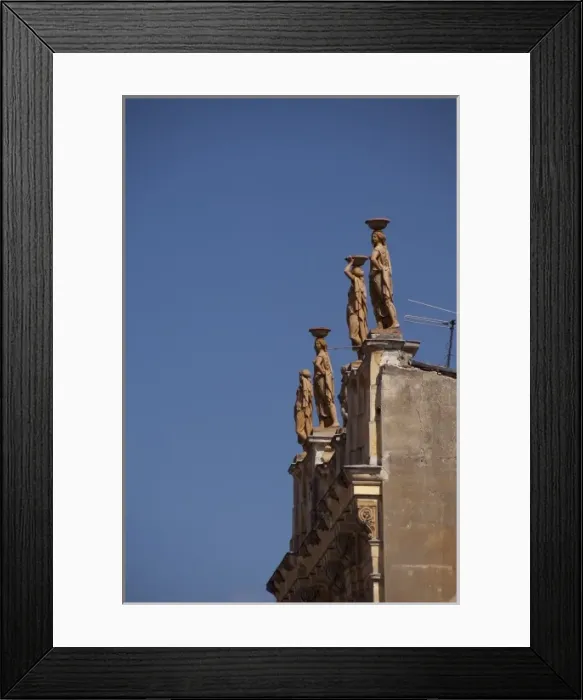 Framed Print : Romania, Transylvania, Brasov. Architectural detail of rooftop statues in downtown Brasov
