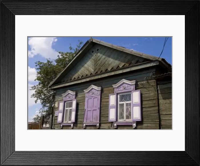 Framed Print : Old wooden worn house with colorful shutters in Irkutsk in Siberia Russia