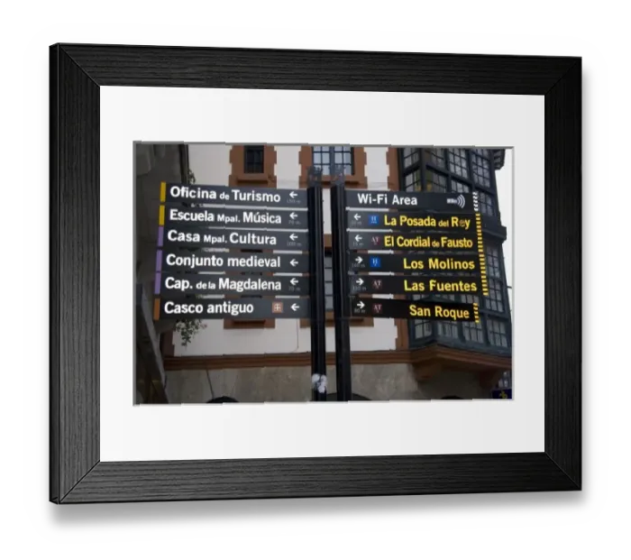 Framed Print : Spanish language direction sign in the town of Llanes, Spain Framed Print : Spanish language direction sign in the town of Llanes, Spain