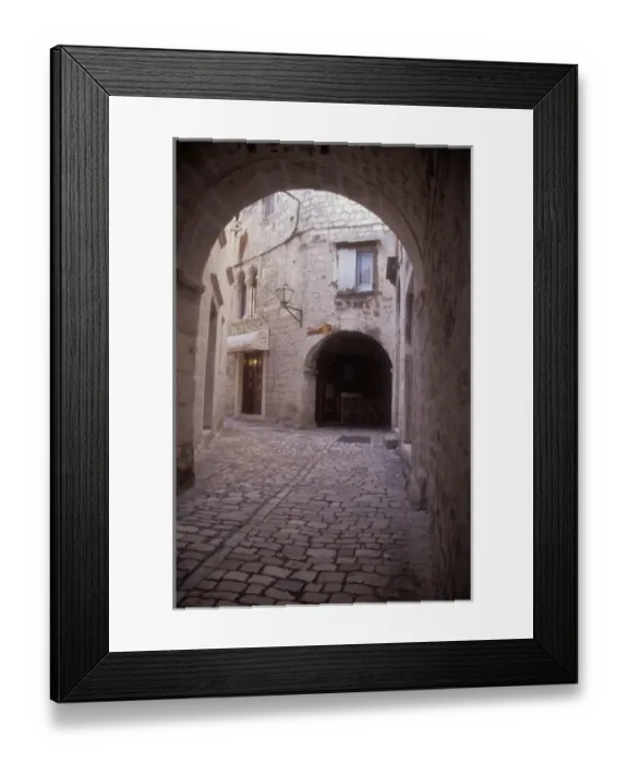 Framed Print : An arched cobbled walkway leads to many residential areas in the central part of Trogir Framed Print : An arched cobbled walkway leads to many residential areas in the central part of Trogir