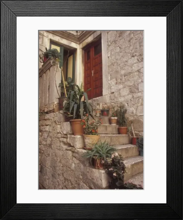 Framed Print : Warm light reflects off the opposite wall to bathe this front porch area. Trogir