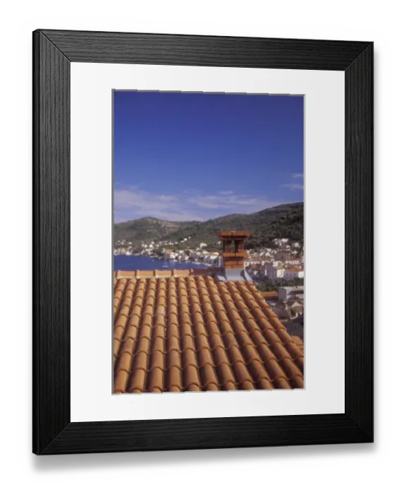 Framed Print : An ochre colored roof of a house up on a hill on the western side of town provides