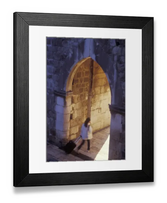 Framed Print : A tourist briskly walks through the inner gate at the Pile Gate entrance to Old Town Dubrovnik Framed Print : A tourist briskly walks through the inner gate at the Pile Gate entrance to Old Town Dubrovnik