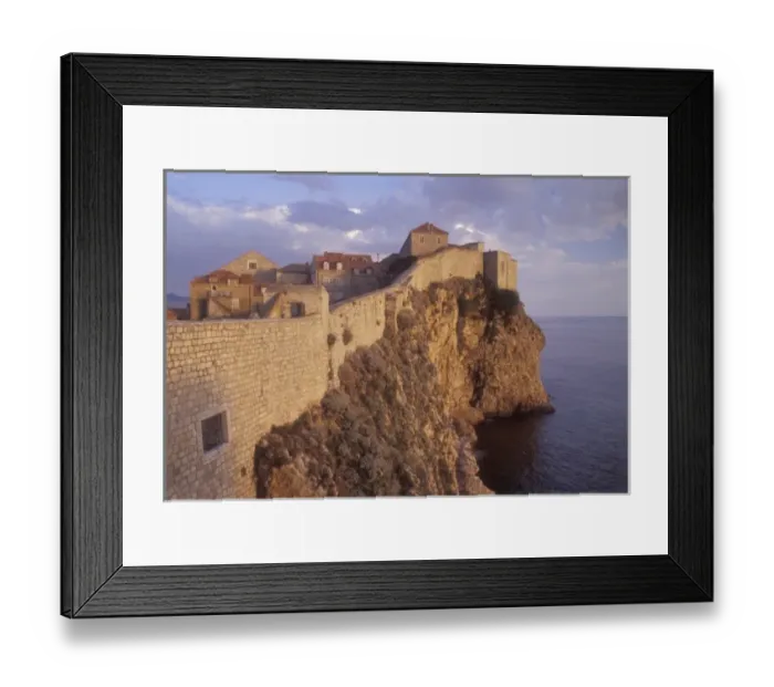 Framed Print : Late Afternoon light creates a warm glow on the rocky coastline and ancient historic Framed Print : Late Afternoon light creates a warm glow on the rocky coastline and ancient historic