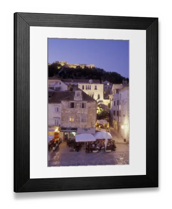 Framed Print : Diners enjoy a meal in the main town square (Trg Sv Stjepana) with Fortress Spanjol