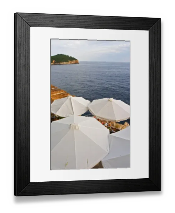 Framed Print : White sun shade umbrellas at a cafe on the city wall overlooking the sea Framed Print : White sun shade umbrellas at a cafe on the city wall overlooking the sea