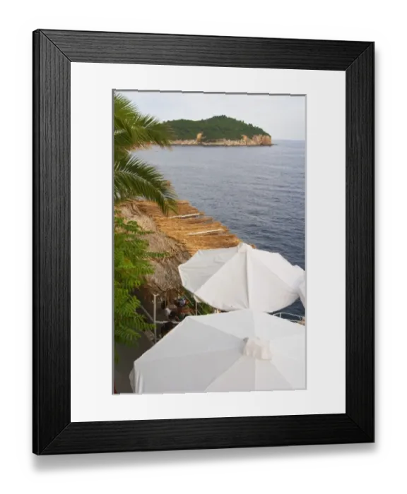 Framed Print : White sun shade umbrellas at a cafe on the city wall overlooking the sea Framed Print : White sun shade umbrellas at a cafe on the city wall overlooking the sea