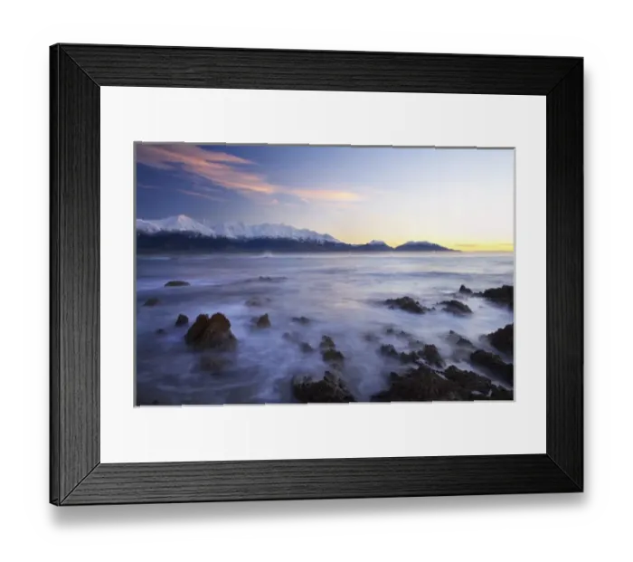 Framed Print : New Zealand, South Island, Kaikoura, Waves on Rocks and Seaward Kaikoura Range at Dawn
