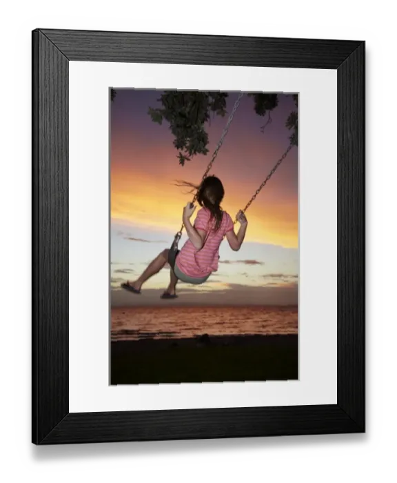 Framed Print : Young Girl on Rope Swing under Pohutukawa Tree at Sunset, Thames, Coromandel, North Island