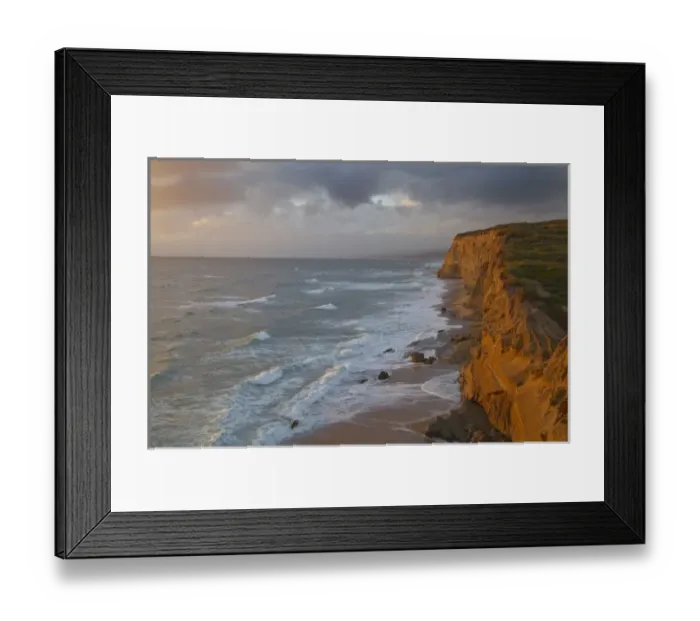 Framed Print : Sea cliffs catch days last light at Pomponi State Beach in San Mateo County, California