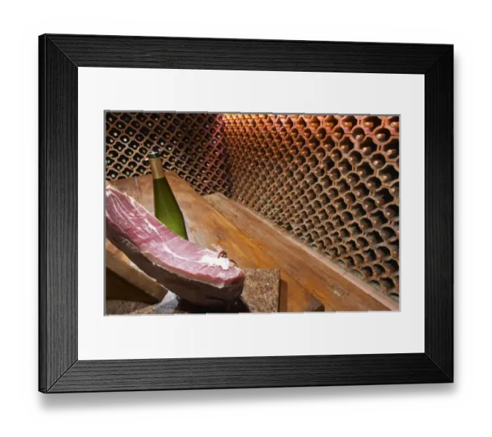 Framed Print : The wine cellar and tasting room, walls are lined with bottles stacked in terracotta