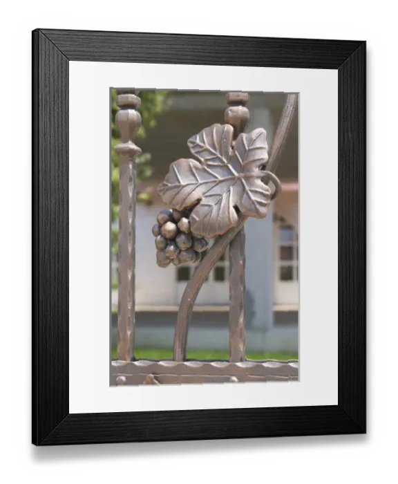 Framed Print : Wrought iron grape bunch and vine leaf on the entrance gate to the winery. Podrum Framed Print : Wrought iron grape bunch and vine leaf on the entrance gate to the winery. Podrum