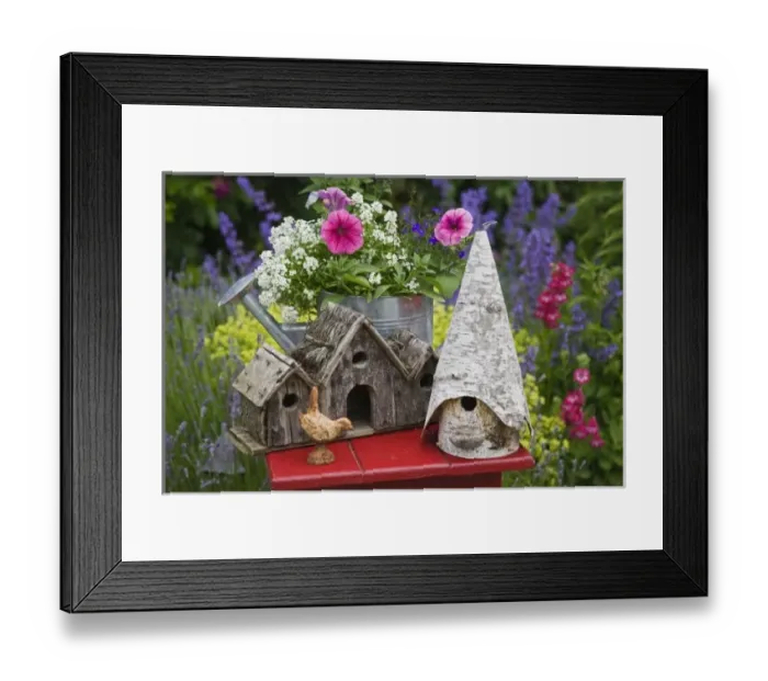 Framed Print : Close-up of bird houses and planter on garden table Framed Print : Close-up of bird houses and planter on garden table