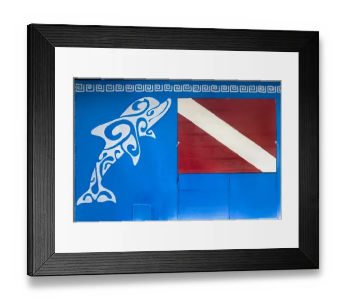 Framed Print : French Polynesia, Society Islands, Rangiroa. A dolphin and dive flag painted on Framed Print : French Polynesia, Society Islands, Rangiroa. A dolphin and dive flag painted on