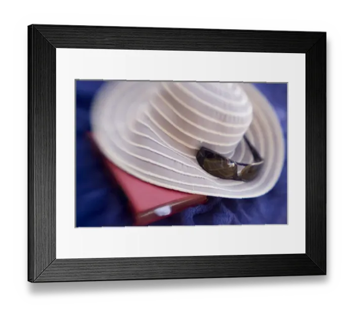 Framed Print : French Polynesia. Sun hat, sunglasses and book on a blue towel