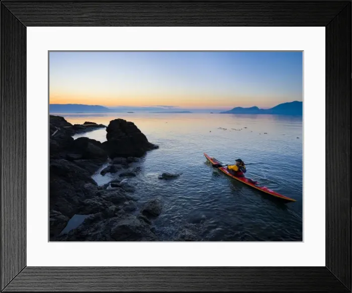 Framed Print : USA, Washington State, San Juan Islands, Doe Island. Woman sea kayaker paddling at dawn Framed Print : USA, Washington State, San Juan Islands, Doe Island. Woman sea kayaker paddling at dawn