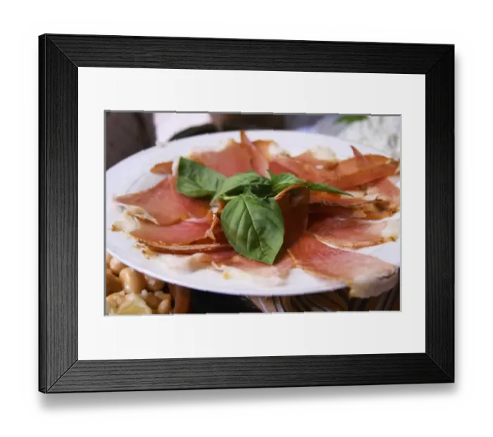 Framed Print : Dried dry cured ham with basil leaves on a white plate. Tradita traditional restaurant, Shkodra