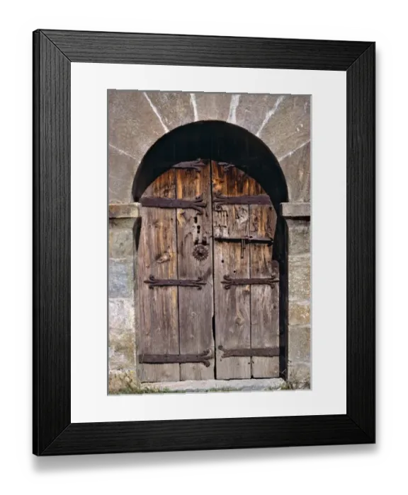 Framed Print : Europe, Andorra. An ancient old wooden door contrasts against a stone building in Andorra