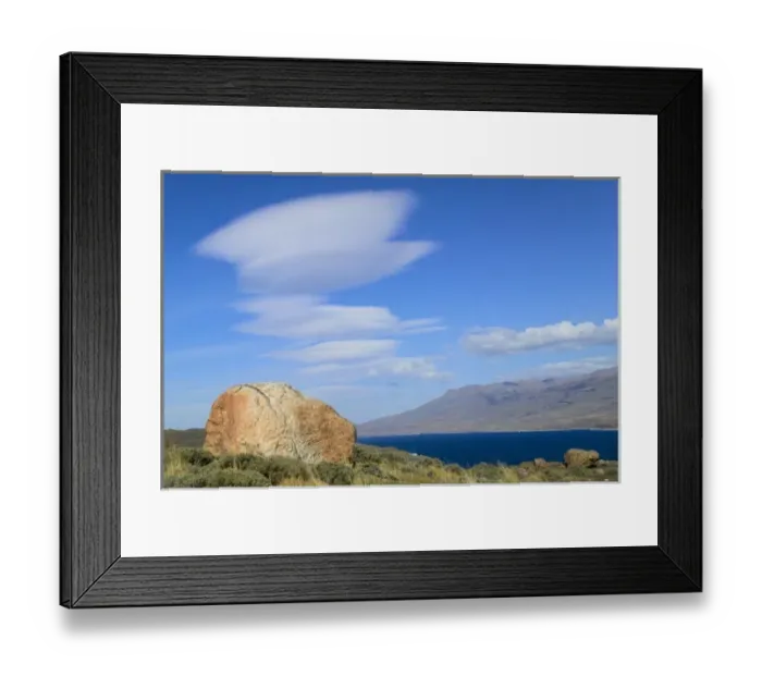Framed Print : Dramatic clouds in the blue sky over meadow and Lago Pehoe, Torres del Paine National Park