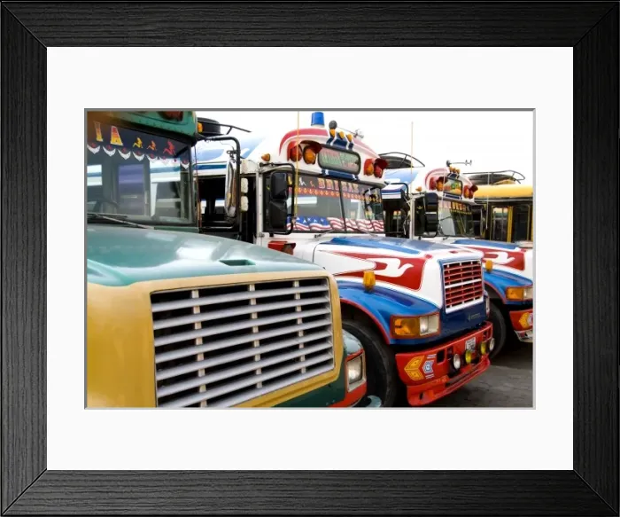 Framed Print : Colorful chicken buses for transportation near market in tourist village of Antigua Framed Print : Colorful chicken buses for transportation near market in tourist village of Antigua