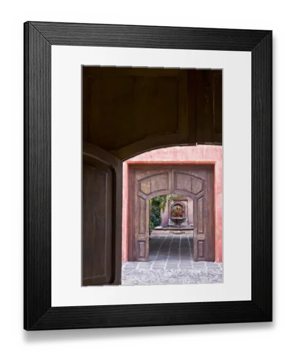 Framed Print : Guatemala, Antigua. Looking through two doorways at a hotel fountain decorated with flowers