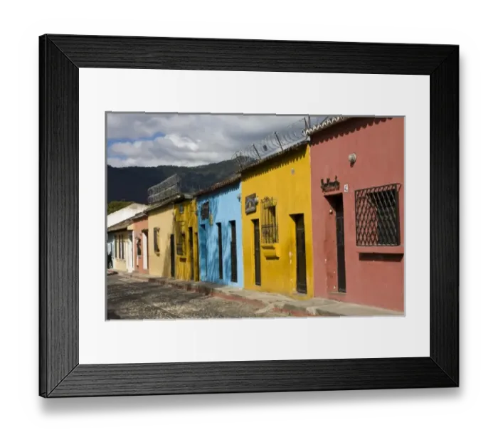 Framed Print : Guatemala, Antigua. Colorful houses along the town of Antigua