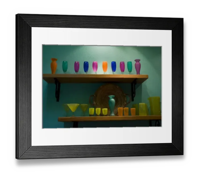Framed Print : Mexico, San Miguel de Allende. Colorful collection of glassware on two shelves against Framed Print : Mexico, San Miguel de Allende. Colorful collection of glassware on two shelves against