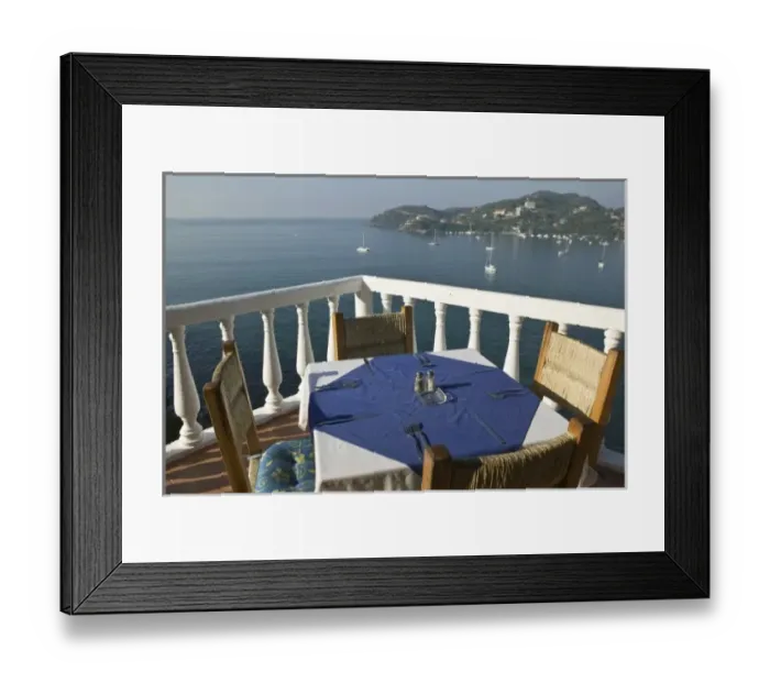 Framed Print : Mexico, Guerrero, Zihuatanejo. Cafe Table over Zihuatanejo Bay
