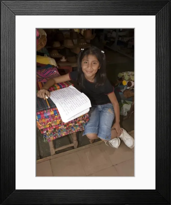 Framed Print : Nicaragua, Masaya. Girl doing schoolwork at shop in Masaya market Framed Print : Nicaragua, Masaya. Girl doing schoolwork at shop in Masaya market
