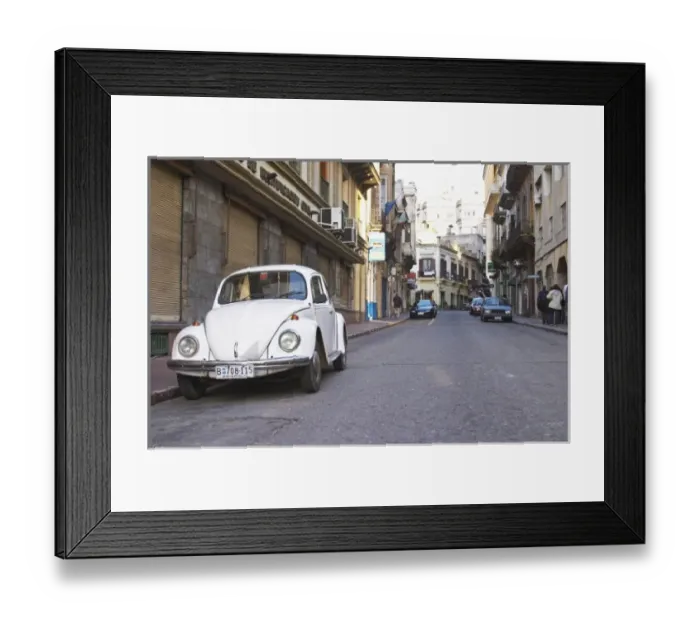 Framed Print : An old white Volksvagen Beetle probably from the 1960s parked on the street in