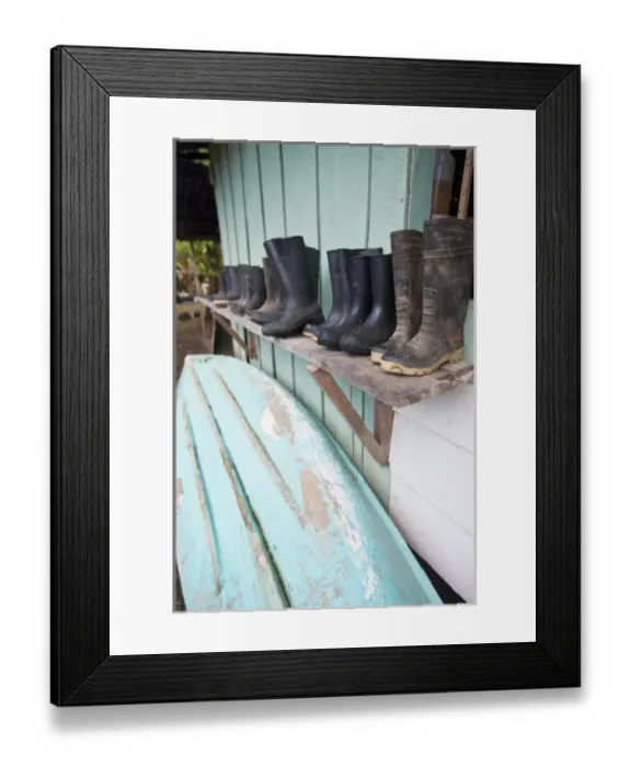 Framed Print : Wet season supplies including rubber boots, canoes and oars line a shed at Sirena Framed Print : Wet season supplies including rubber boots, canoes and oars line a shed at Sirena