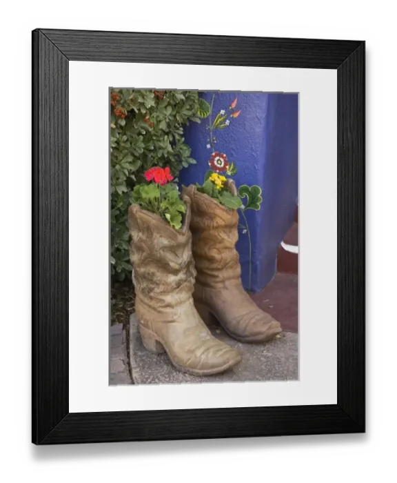 Framed Print : USA, Arizona, Tucson. Cowboy boots used as planters on porch of Hacienda Del Sol Guest Ranch Resort