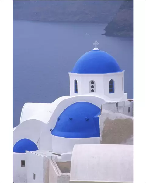 Greece, Santorini, Oia. Blue domed church overlooking the Sea of Crete