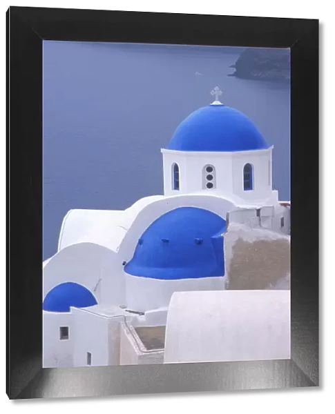 Greece, Santorini, Oia. Blue domed church overlooking the Sea of Crete