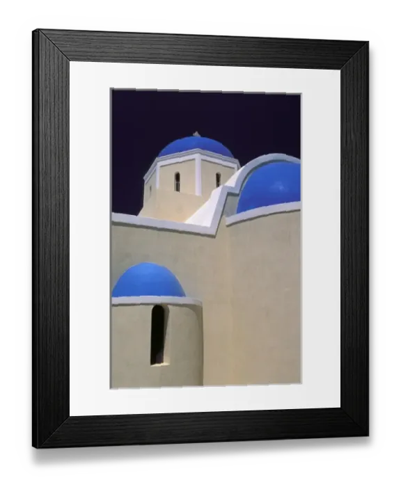 Framed Print : Oia, Santorini, Greece, Blue domes upon a white church illuminated by the sun in the village of Oia