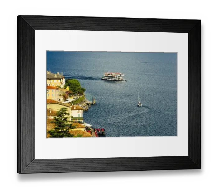 Framed Print : Italy, Lake Garda. A ferry arrives at the lake village of Limone