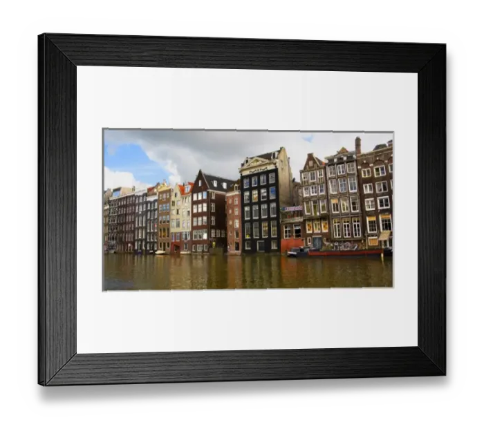 Framed Print : View of the unique architecture and gabled homes and coffee shop along a colorful canal