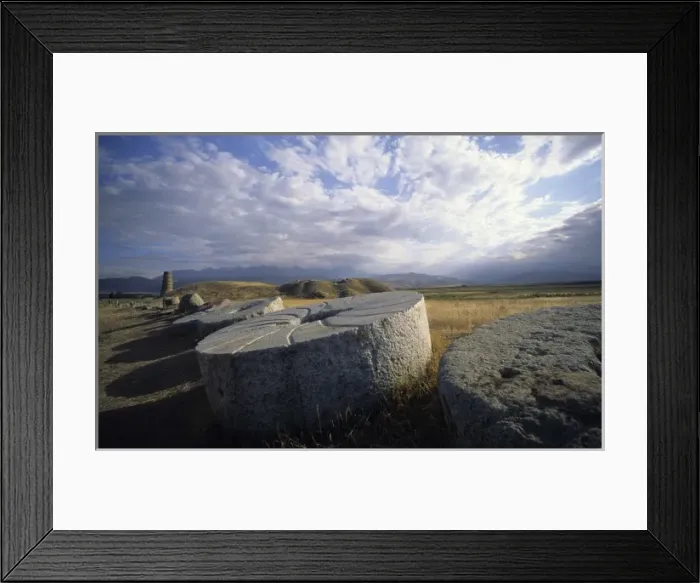 Framed Print : Huge ancient grinding wheels and Burana Tower, Kirghizstan, Central Asia