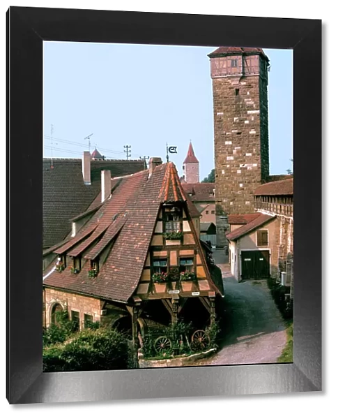 Germany, Bavaria, Rothenburg ob der Tauber. A quaint home resides at the foot of