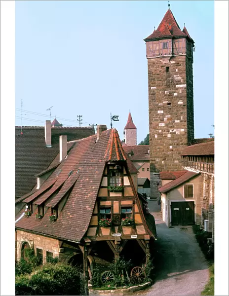 Germany, Bavaria, Rothenburg ob der Tauber. A quaint home resides at the foot of