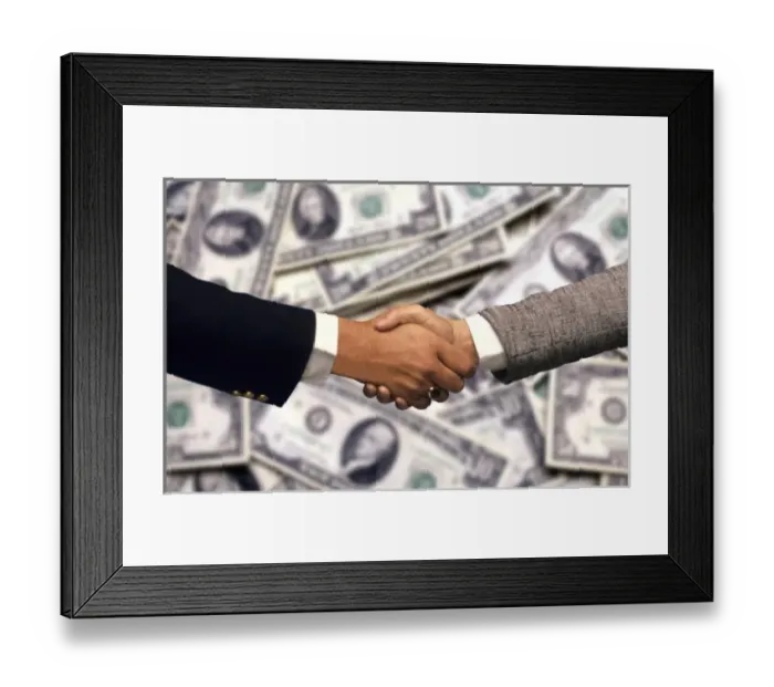 Framed Print : Two businessmen, in front of US currency, shaking hands to close a deal