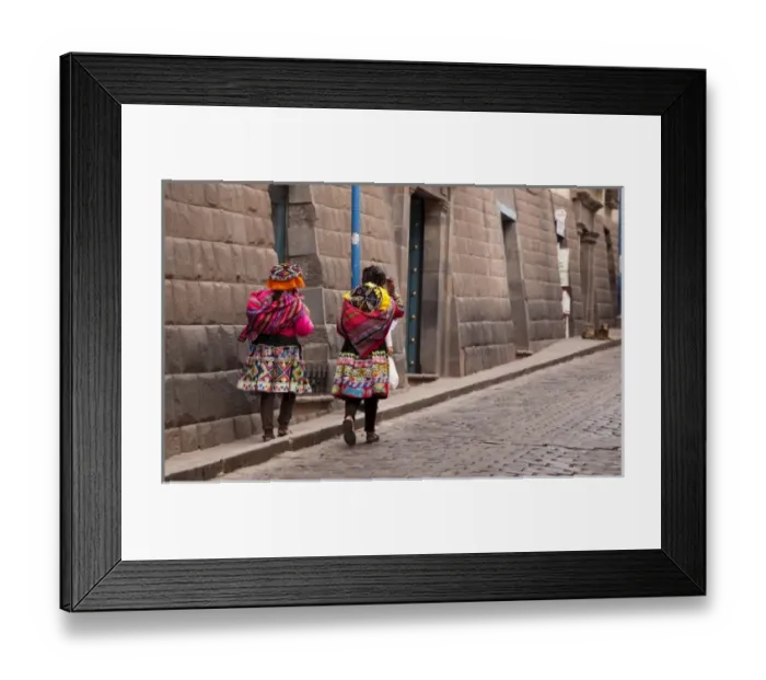 Framed Print : South America, Peru, Cuzco. Two women in traditional dress walk along the stone street Framed Print : South America, Peru, Cuzco. Two women in traditional dress walk along the stone street