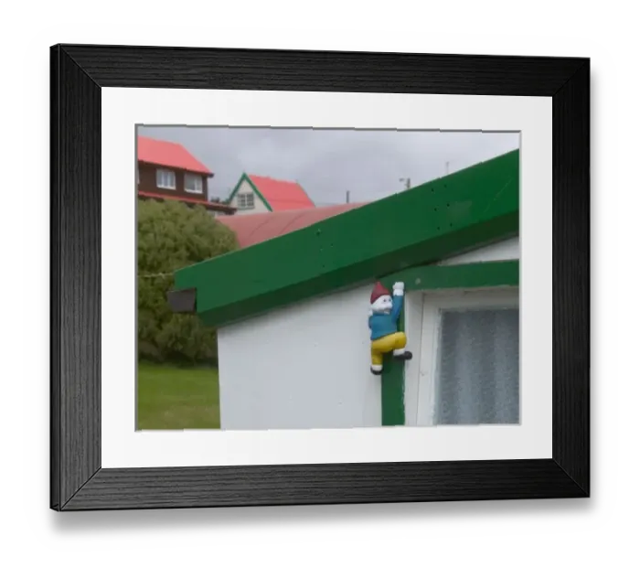 Framed Print : Window decorated with a little climbing figure, Port Stanley, Falkland Islands