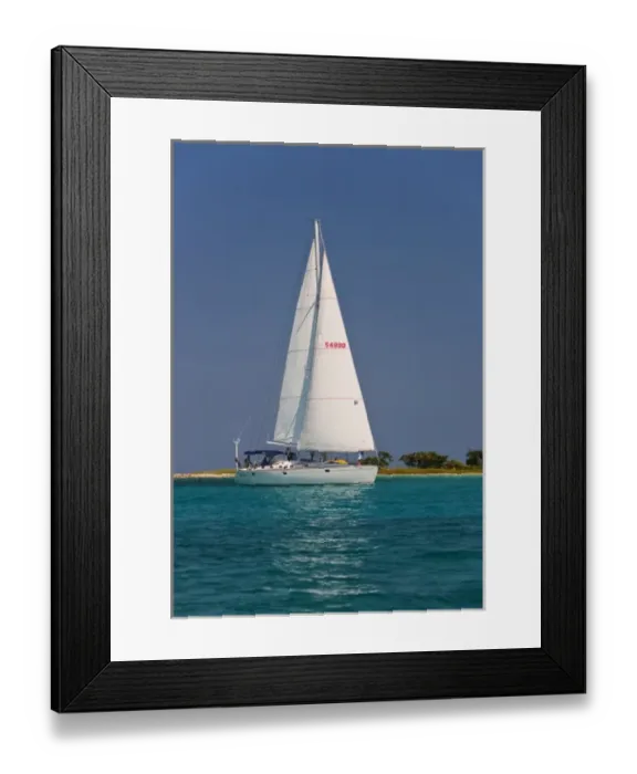 Framed Print : A sail boat sailing by Laughing Bird Cay in Belize Framed Print : A sail boat sailing by Laughing Bird Cay in Belize