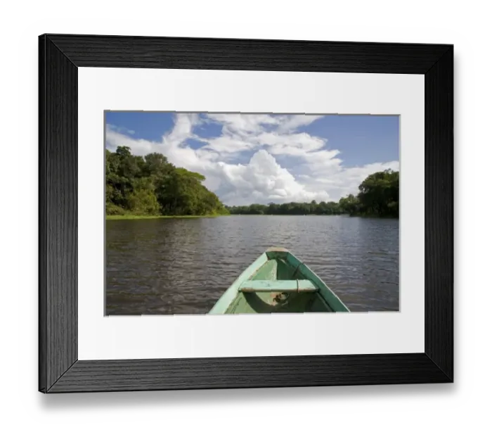 Framed Print : The bow of a dugout canoe on the Arasa River in the Amazon jungle near Manaus, Brazil